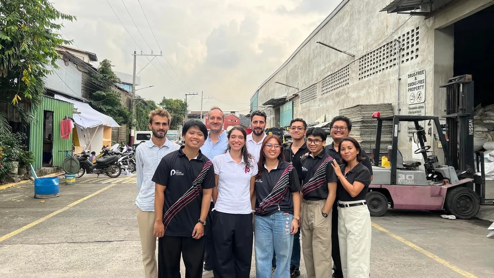 The Plastic Flamingo team members standing together outside the company's recycling facility