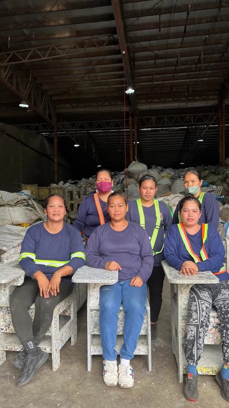 Women workers seated on recycled-plastic chairs at The Plastic Flamingo facility