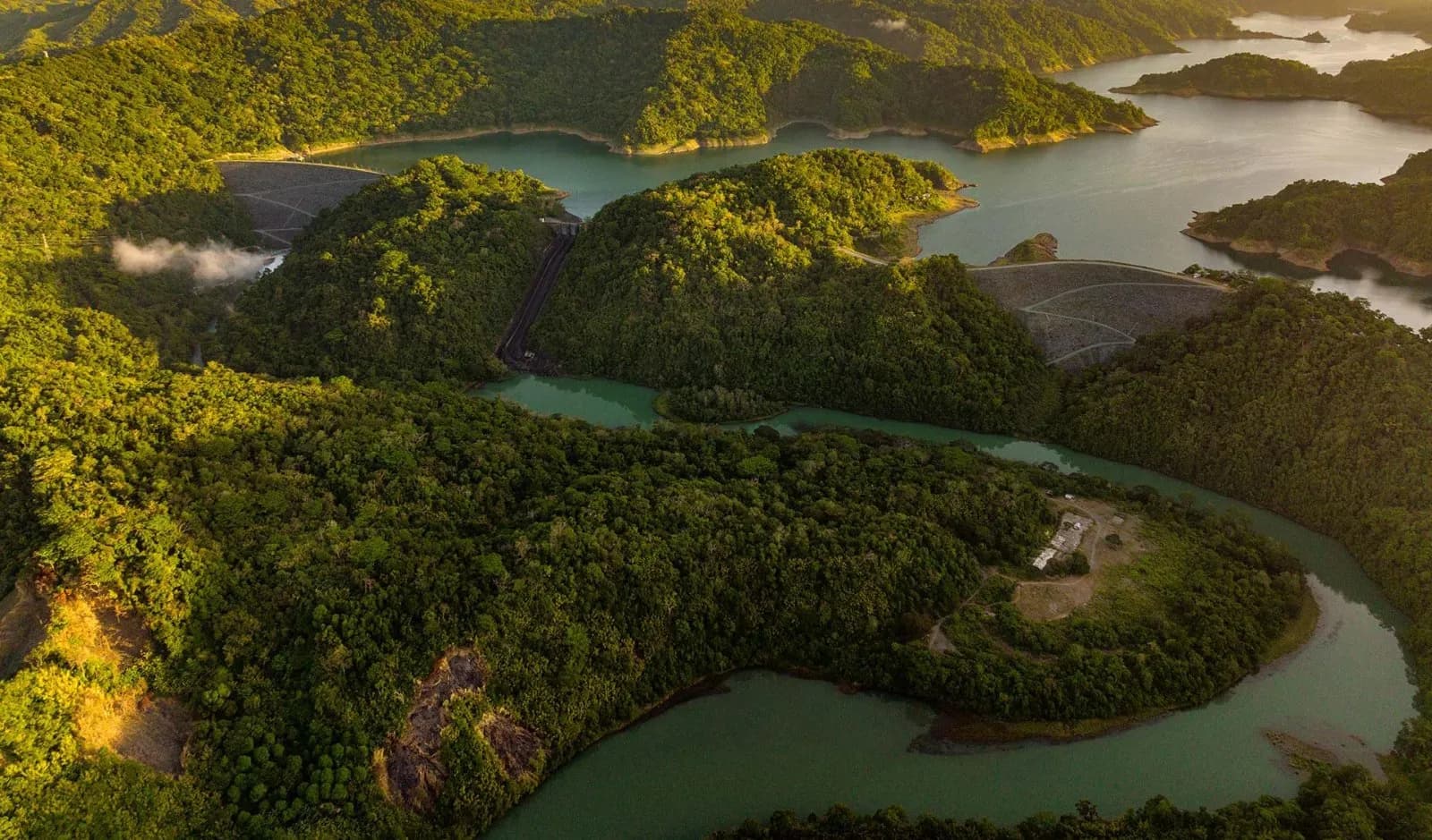 Aerial view of a forested watershed and reservoir