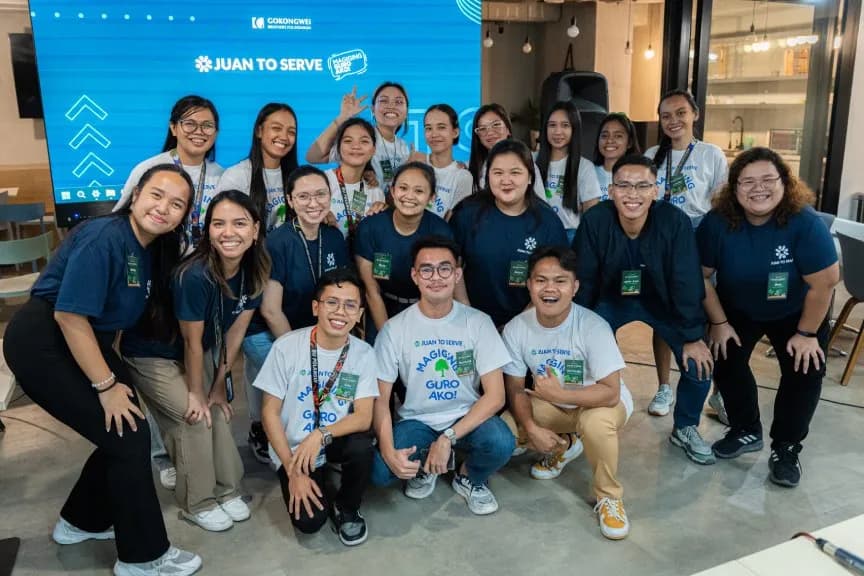 A group of young volunteers and teachers in matching shirts posing at a Gokongwei Brothers Foundation event